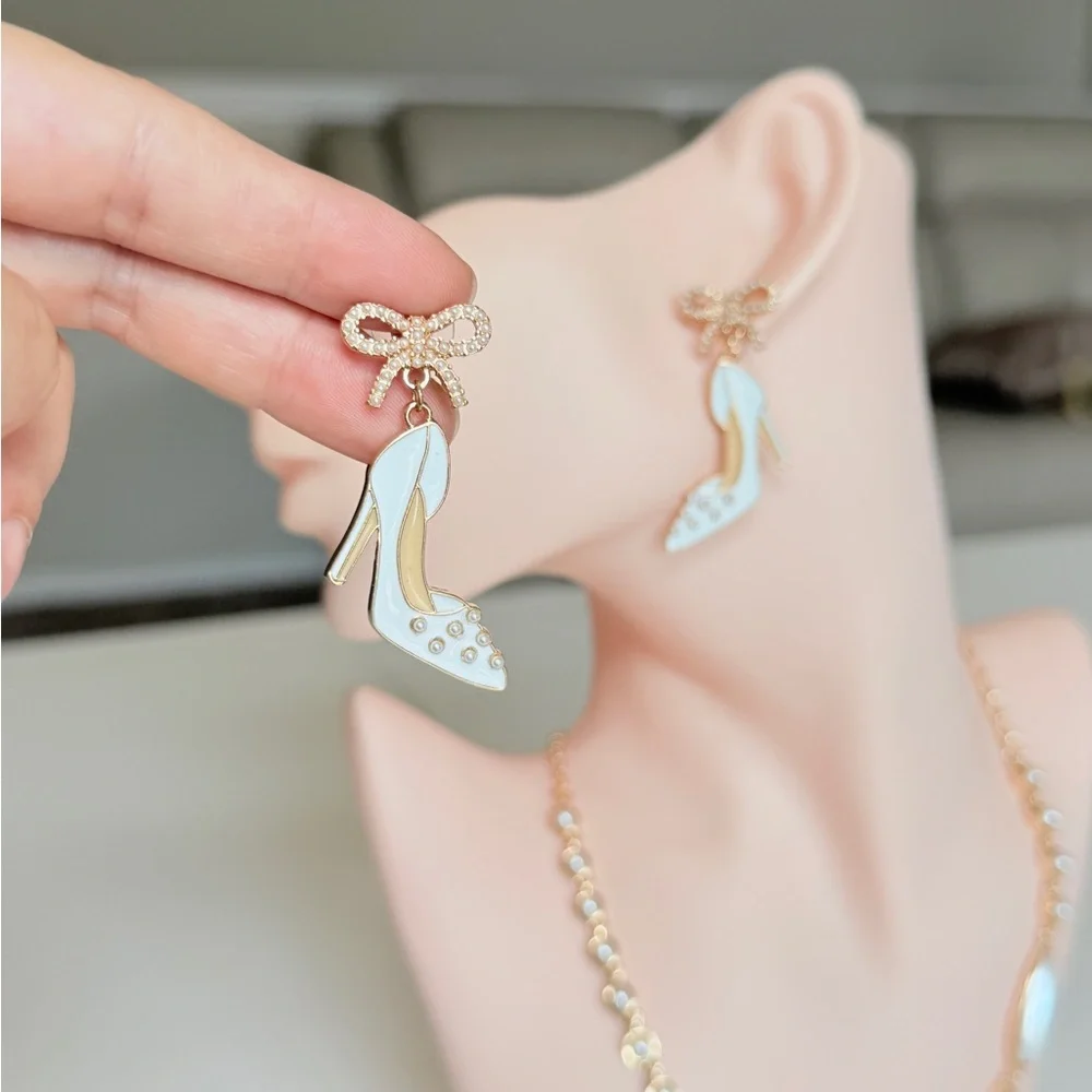 White Enamel High Heel Drop Earrings with Gold Bow